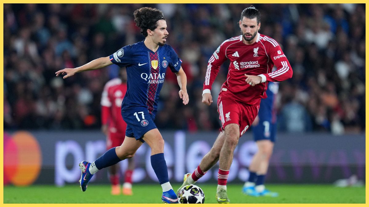 Vitinha of Paris Saint-Germain runs with the ball while under pressure from Dominik Szoboszlai of Liverpool during the UEFA Champions League 2025/26 Quarter-Final First Leg match between Paris Saint-Germain FC and Liverpool FC at Parc des Princes