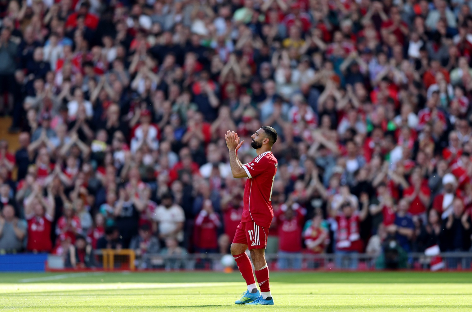 Mo Salah applauds the fans as he leaves the pitch with a suspected hamstring injury