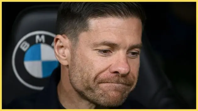 Xabi Alonso grimaces while sat on the bench.