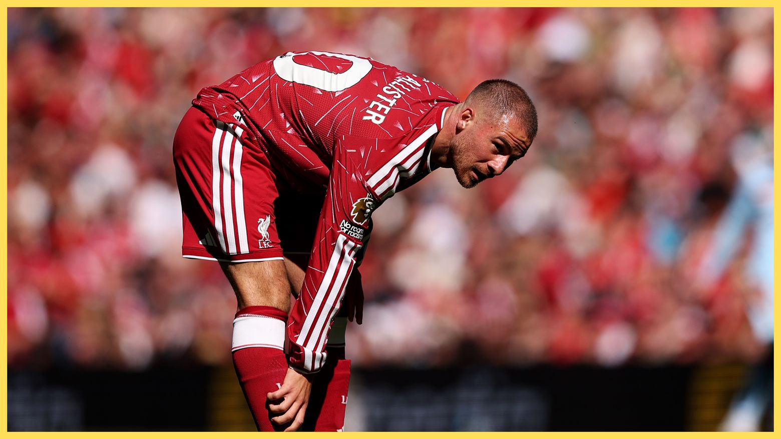 Reported Real Madrid target Alexis Mac Allister rubs his shin during a Liverpool game in the Premier League.
