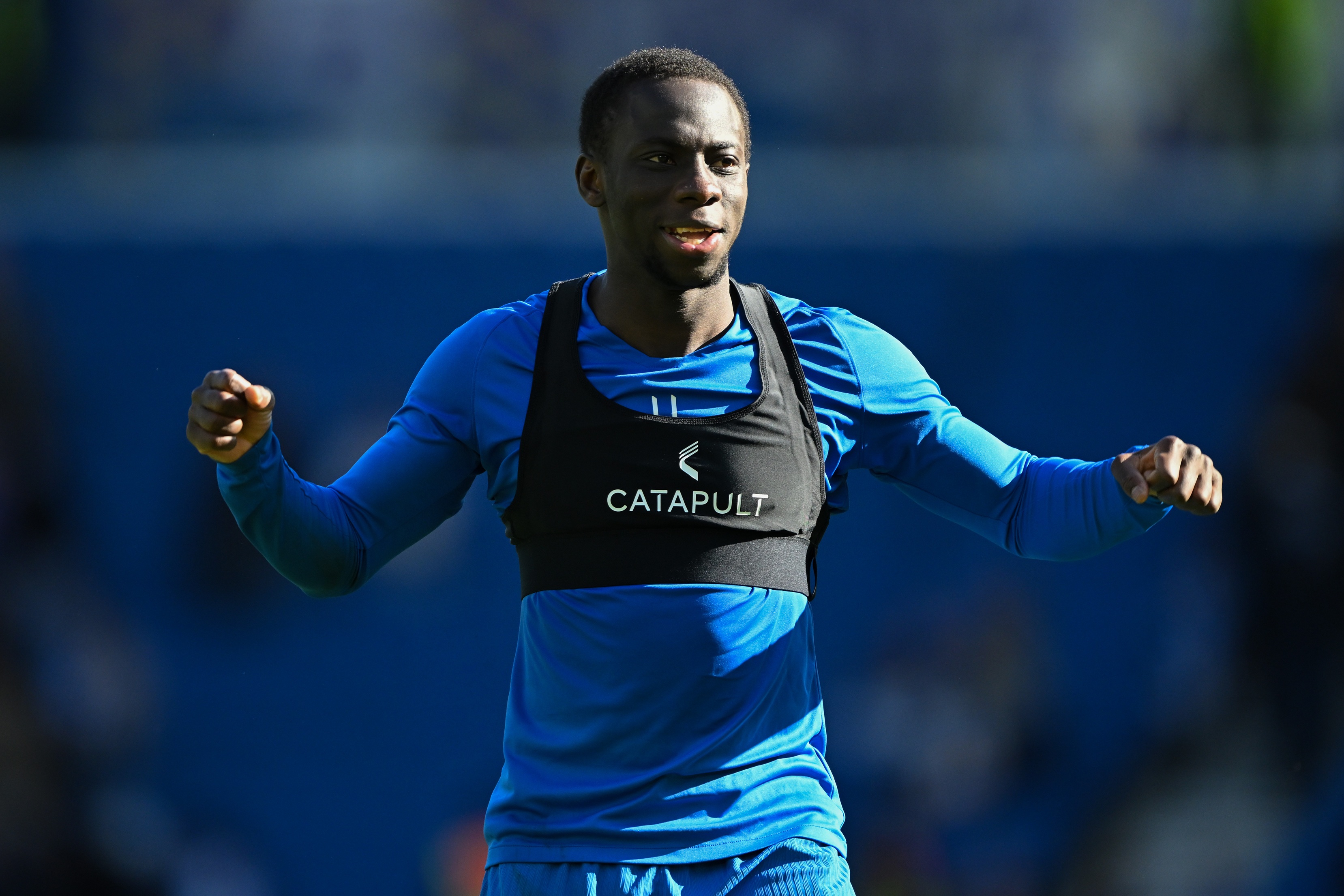 Yankuba Minteh punches his arms out during Brighton game.