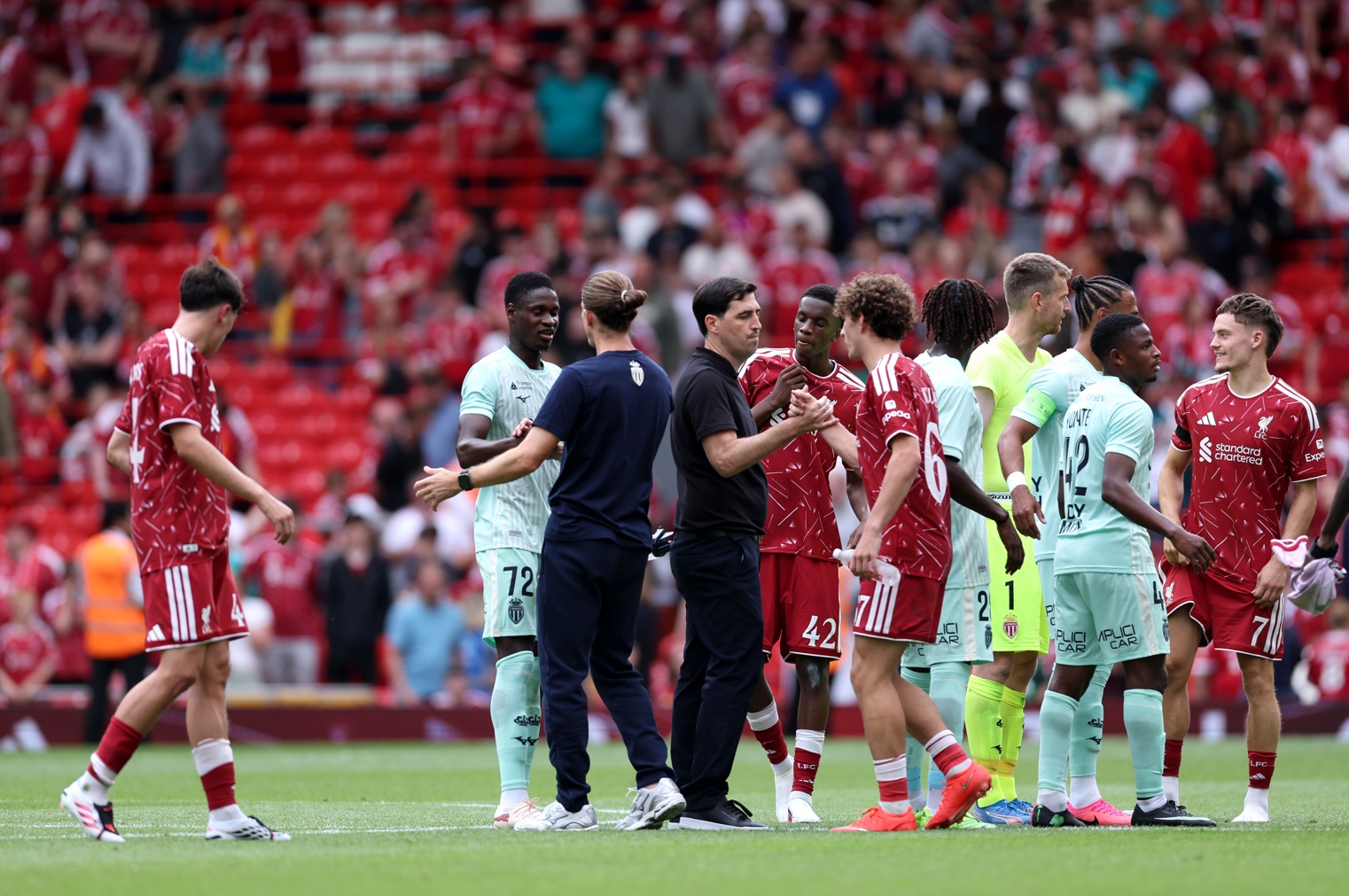 Liverpool and Monaco players shake hands after the final whistle at Anfield