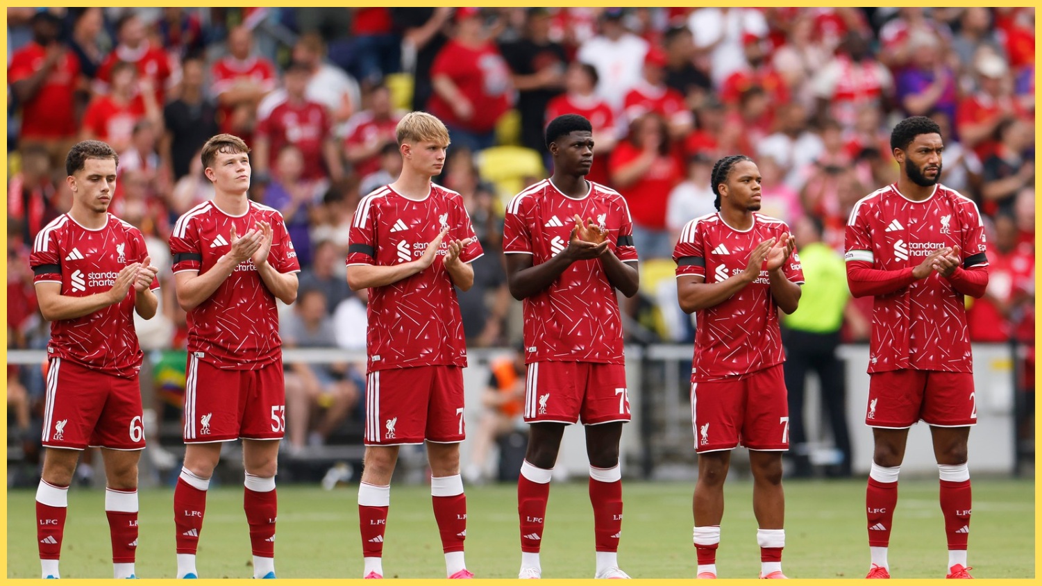 Liverpool players observe a minute's applause before kick-off